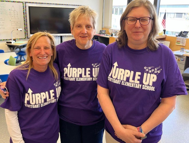 Teachers wearing purple up shirts